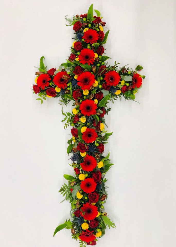 <h2>Large Classic Cross-Shaped Design | Funeral Flowers</h2>
<br>
<ul>
<li>Approximate Size W 45cm H 130cm (4ft)</li>
<li>Hand created large classic cross in fresh flowers</li>
<li>To give you the best we may occasionally need to make substitutes</li>
<li>Funeral Flowers will be delivered at least 2 hours before the funeral</li>
<li>For delivery area coverage see below</li>
</ul>
<br>
<h2>Liverpool Flower Delivery</h2>
<br>
<p>We have a wide selection of Funeral Crosses offered for Liverpool Flower Delivery. Funeral Crosses can be provided for you in Liverpool, Merseyside and we can organize Funeral flower deliveries for you nationwide. Funeral Flowers can be delivered to the Funeral directors or a house address. They can not be delivered to the crematorium or the church.</p>
<br>
<h2>Flower Delivery Coverage</h2>
<br>
<p>Our shop delivers funeral flowers to the following Liverpool postcodes L1 L2 L3 L4 L5 L6 L7 L8 L11 L12 L13 L14 L15 L16 L17 L18 L19 L24 L25 L26 L27 L36 L70 If your order is for an area outside of these we can organise delivery for you through our network of florists. We will ask them to make as close as possible to the image but because of the difference in stock and sundry items it may not be exact.</p>
<br>
<h2>Liverpool Funeral Flowers | Crosses</h2>
<br>
<p>This large classic funeral cross has been loving handcrafted by our expert florists and features a colourful mix of gerberas, chrysanthemums, spray roses, eryngium and luscious green foliage to complete this traditional design.</p>
<br>
<p>Funeral crosses are symbols of belief they reaffirm faith and provide comfort at this difficult time.</p>
<br>
<p>In the larger sizes (from 4ft up) they are appropriate as the main tribute but smaller sizes are sometimes chosen by close friends as they represent extremely personal sentiments and feelings.</p>
<br>
<p>Containing 14 red gerberas, 3 red spray roses, 5 yellow spray chrysanthemums, 5 green hypericum (or spray chrysanthemums), 12 red alstroemeria, 4 blue eryngium and seasonal mixed foliage.</p>
<br>
<h2>Best Florist in Liverpool</h2>
<p>Trust Award-winning Liverpool Florist, Booker Flowers and Gifts, to deliver funeral flowers fitting for the occasion delivered in Liverpool, Merseyside and beyond. Our funeral flowers are handcrafted by our team of professional fully qualified who not only lovingly hand make our designs but hand-deliver them, ensuring all our customers are delighted with their flowers. Booker Flowers and Gifts your local Liverpool Flower shop.</p>
<br>
<p><em>Janice Crane - 5 Star Review on Google - Funeral Florist Liverpool</em></p>
<br>
<p><em>I recently had to order a floral tribute for my sister in laws funeral and the Booker Flowers team created a beautifully stunning arrangement. Thank you all so much, Janice Crane.</em></p>